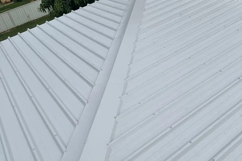 Newly laid pale grey COLORBOND steel roof sheeting and ridge capping